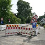 a road closed off with barricades and signs