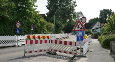 a road closed off with barricades and signs